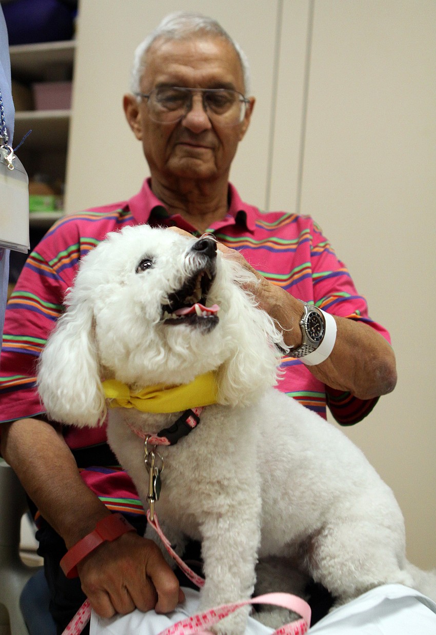 Finnegan gives a big smile while she gets some scratches from Brian Bain.