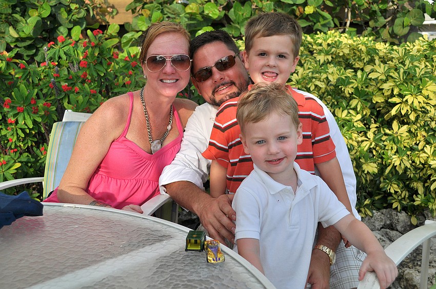 Jennifer, Drew, Roman, 4, and Cort, 2, Griffin enjoy some quality family time Sunday, July 3 at the Lobster BBQ by the pool at Longboat Key Club Resort.