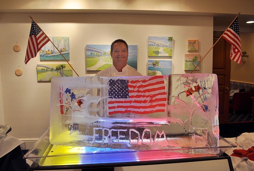 Dave Andrews with the ice sculpture he created for the Fourth of July event Monday, July 4 at Bird Key Yacht Club.