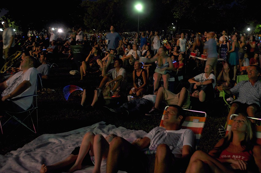 People react to the firework display Monday, July 4 at Island Park.