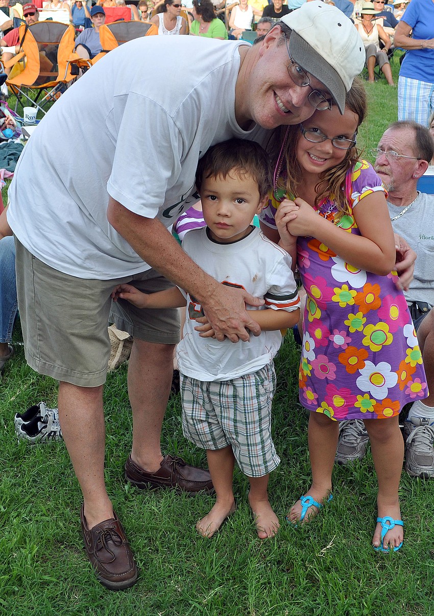 Michael Oâ€™Malley poses with his son, Martin, 3, and daughter Amy, 5, Friday, August 12 during Friday Fest at the Van Wezel.
