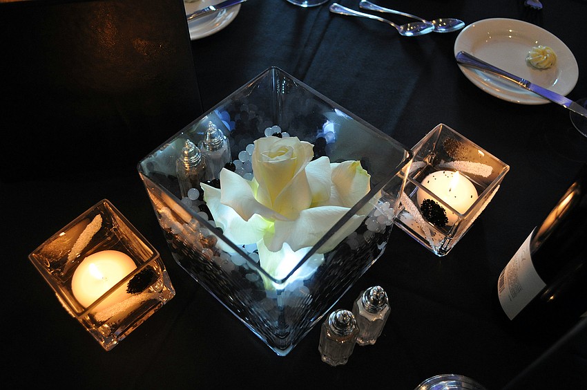 Decorative candles were on every table in the dining room for the SYC Black & White Ball Saturday, August 13 at the Sarasota Yacht Club.