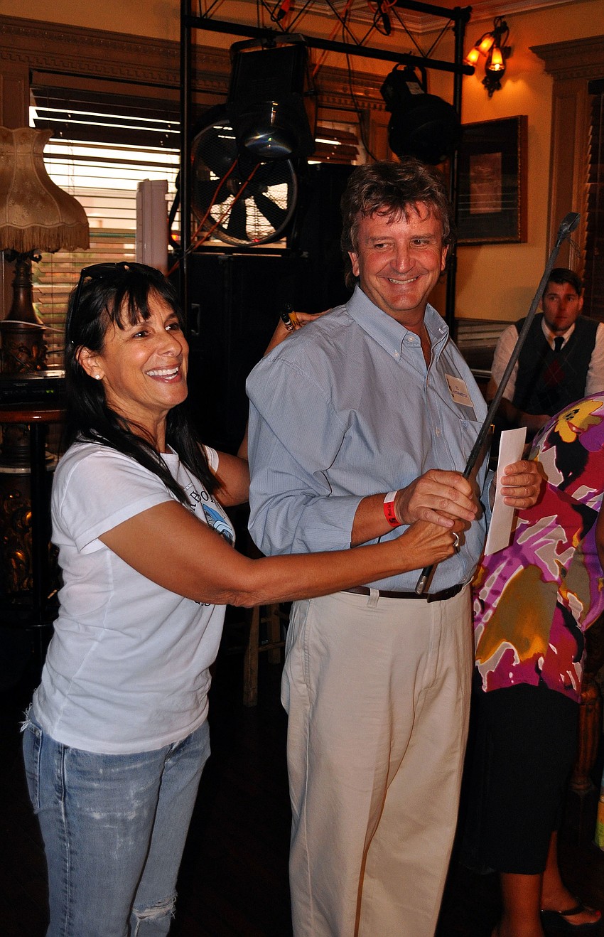 Barbara Strauss passed the whip to Ed Morrell Saturday, August 13 during the Kick Off Party at the Gator Club.