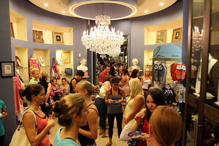 People enjoyed wine from the Sarasota Liquor Locker and food from Bistro 105 Friday, Aug. 26 during Vinyasa & Vino at T. Georgianos.