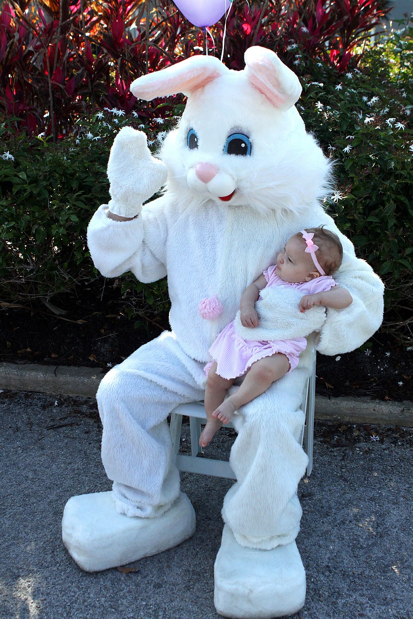 Sophia Dews has her picture taken with the Easter Bunny Sunday, April 24 at Longboat Key Club.