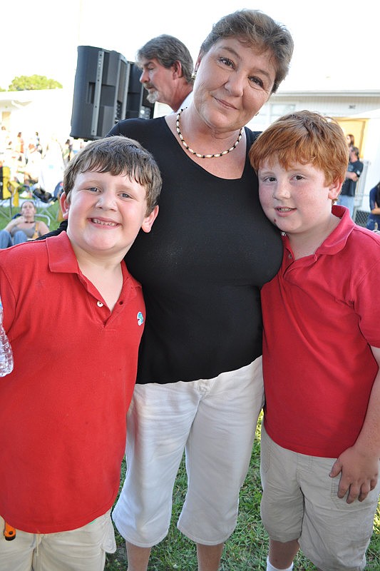Nellie Voegelsong watch her sons Joey, left, and Travis, right, perform.
