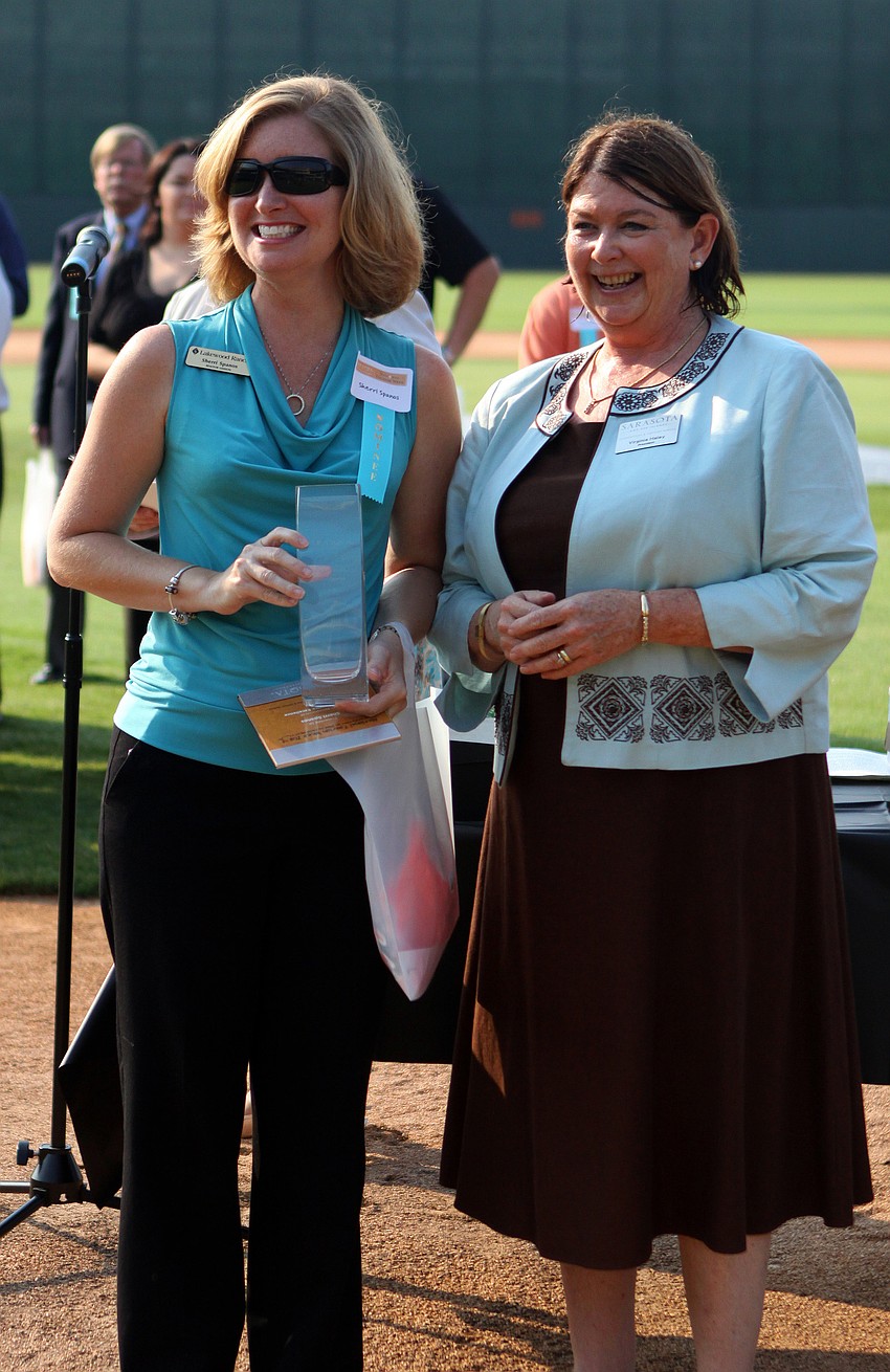 Sherri Spanos, of Lakewood Ranch Communities, holds her award for Guest Service Excellence - Back of House - Visitor Services at the 2011 National Tourism Week Awards ceremony Thursday, May 12, at Ed Smith Stadium.