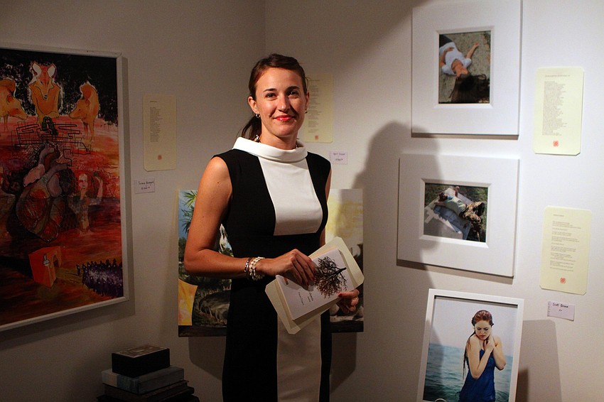 Alexis Orgera poses with her first book of poetry, 