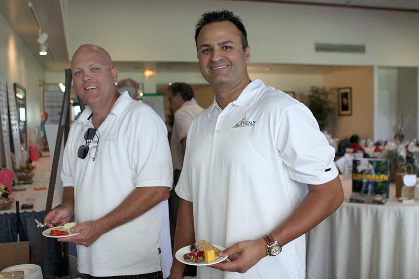 John Rowles and Shezad Moten get some cheese and crackers after playing in the 2011 Longboat Key Invitational Friday, May 27 at the Longboat Key Club Islandside.