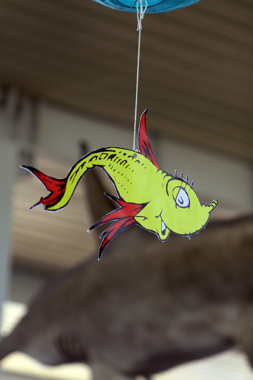 One of the Dr. Seuss fish hangs from an aqua paper lantern as part of one of the decorations put up for the World Ocean Day Family Festival Sunday, June 5 at Mote Aquarium.