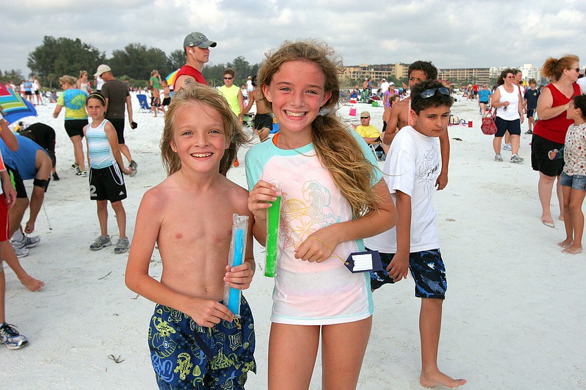 George, 9, and Sarah, 10, Harding enjoy their freeze pops after running in the 1-mile fun run Tuesday, June 14 on Siesta Key Beach.