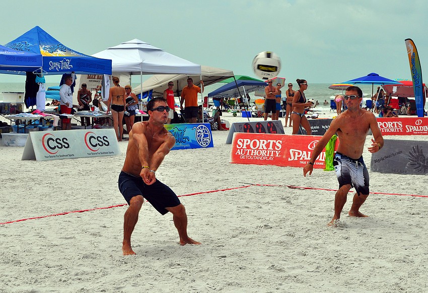 Chris Sweat prepares to hit the ball while his brother and teammate, Nick, stays on his toes during the Siesta Key Gulf Open, Saturday, July 9 at Siesta Key Beach.