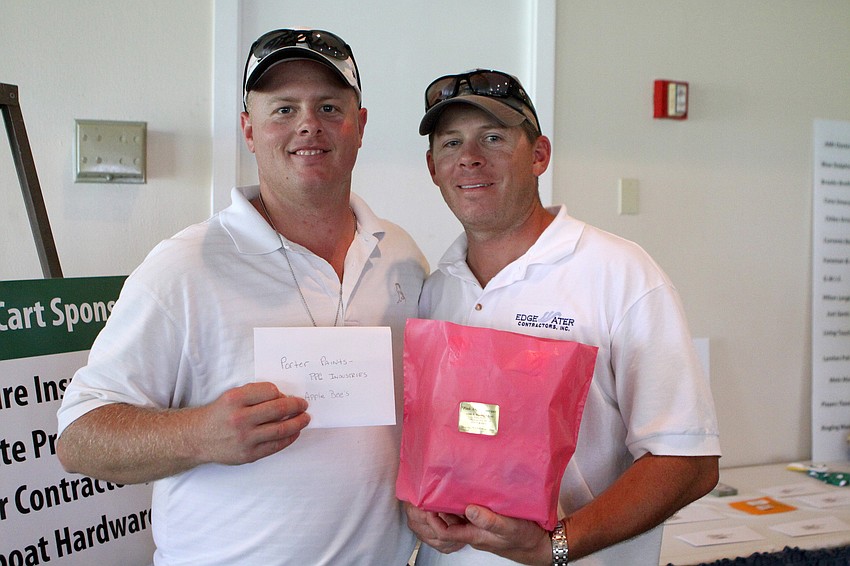 Casey Martin and Jay Anderson show of some of items they won with their raffle tickets at the 2011 Longboat Key Invitational Friday, May 27 at the Longboat Key Club Islandside.