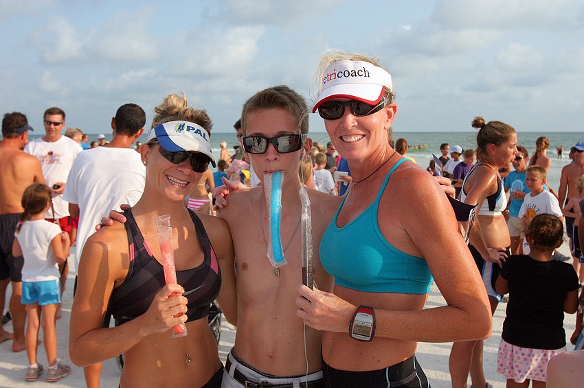 Tanya Marvin, Matthew Chapman, 14,  and Nicole Chapman enjoy their freeze pops after finishing the 1-mile fun run Tuesday, June 14 on Siesta Key Beach.