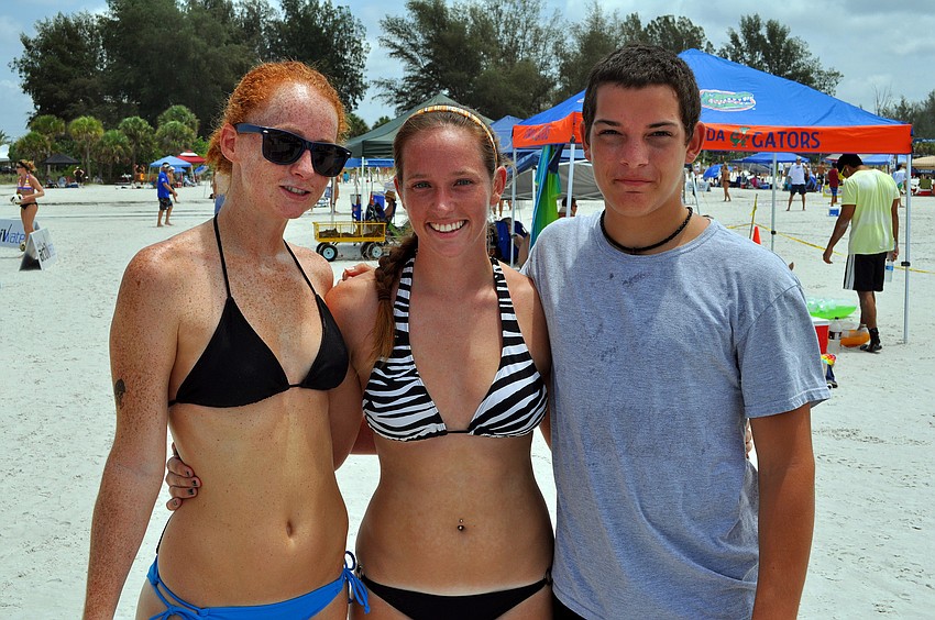 Volleyball teammates Stacy Werse and Melissa Perkins pose with their friend, Victor Davis, Saturday, July 9 at Siesta Key Beach.