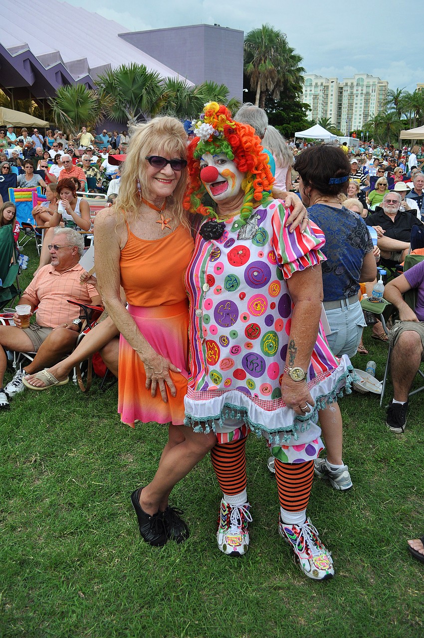 Joya Sutton and Lynda Lilley take a break from dancing to pose together Friday, July 15 at Friday Fest at the Van Wezel.