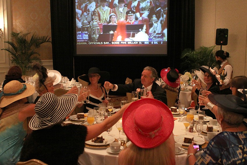People toast to the Duke and Duchess of Cambridge Friday, April 29 while celebrating the royal wedding at the Ritz Carlton.