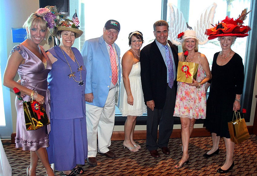 Tami Fox, Sharon Miller, Lee Pokoik, Jennifer Contessa, Larry Goichman, Mari Zevin and Dorothy Lawrence pose as the judges and winners of the Hat Contest on Saturday, May 7 at the Kentucky Derby party at the Sarasota Yacht Club.