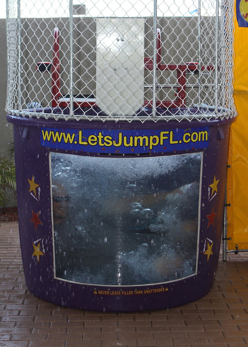 Jason Allen ends up in the water after being dunked in the dunk tank during World Ocean Day Family Festival Sunday, June 5 at Mote Aquarium.