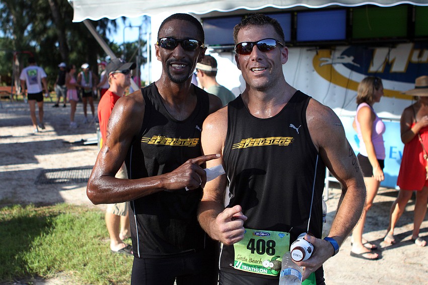 Marcus Dumas and John Blewis pose together after finishing the Siesta Key Triathlon Saturday, July 23 out at Siesta Key Public Beach.