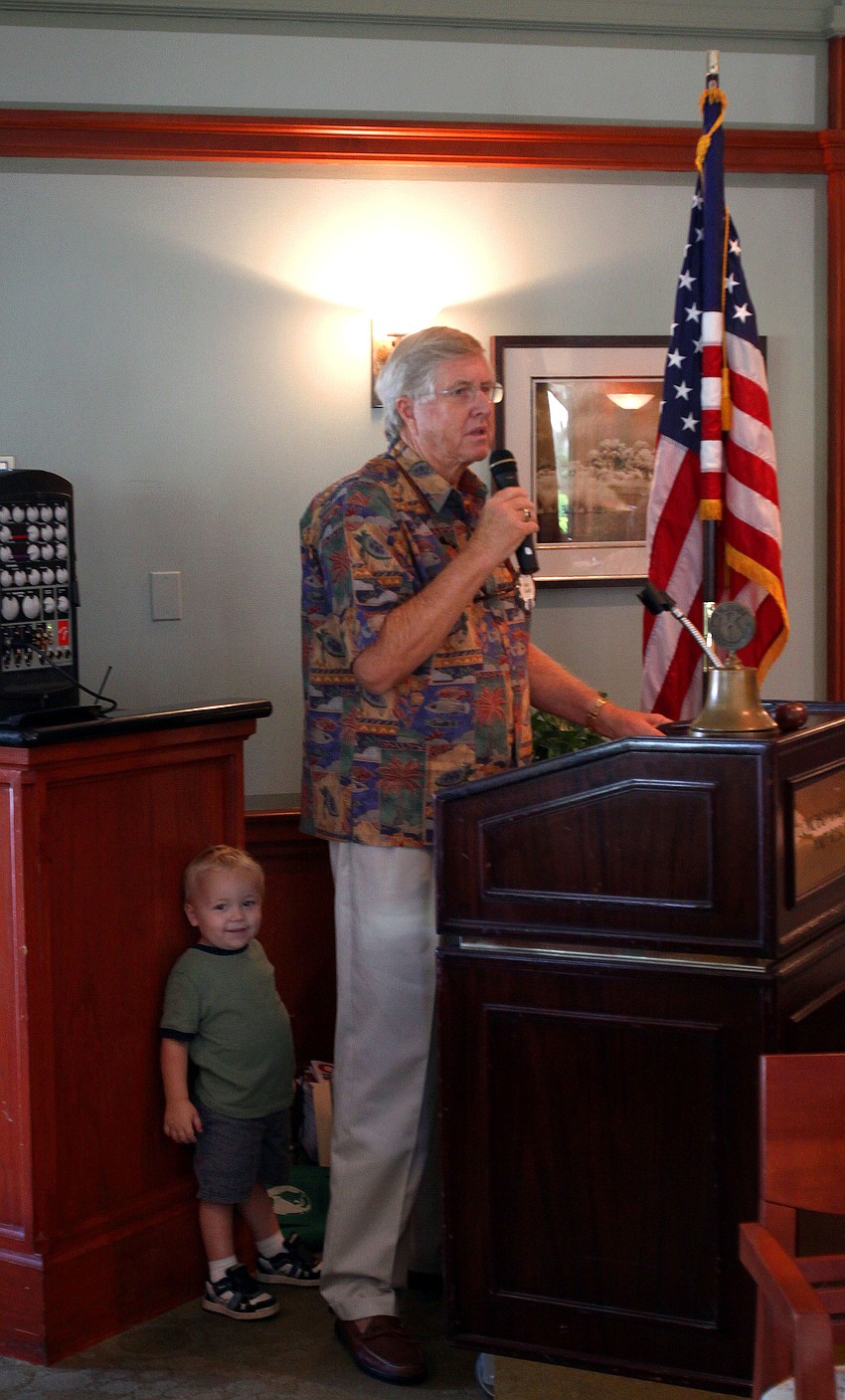 Mason Masciocchi, 2, hides behind Bob Gault near the end of the scholarship breakfast Thursday, Aug. 18, at The Grill.