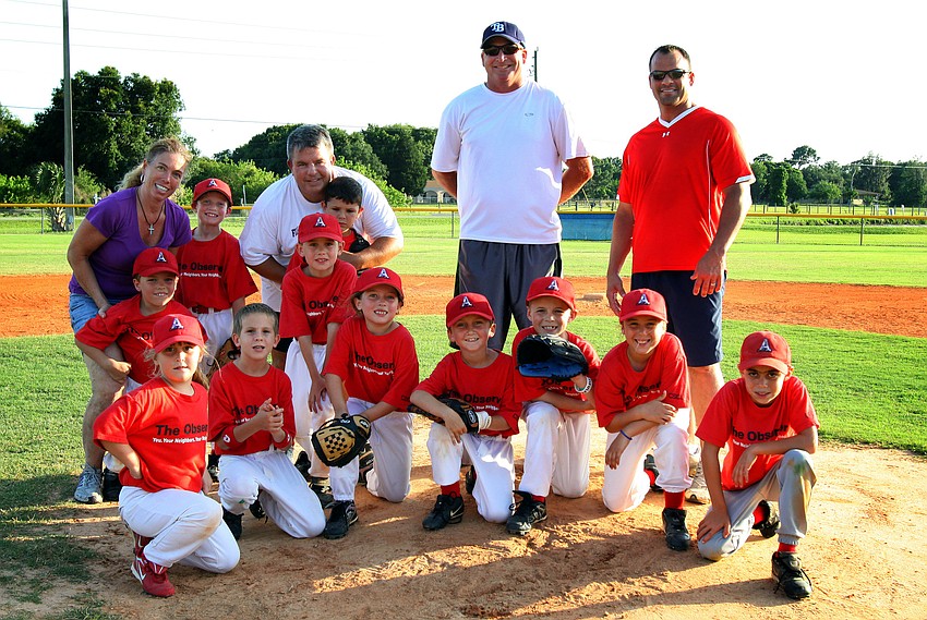 The Observer team poses on the mound after their final game of the Spring season Monday, May 9 out at Twin Lakes Park.