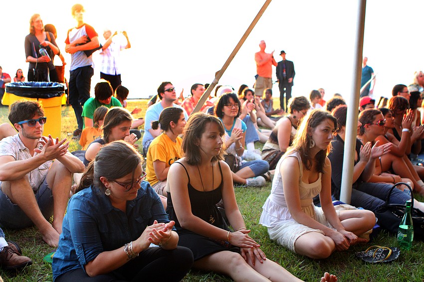 Younger students and friends of the graduating class sit just outside of the tent during New College's 2011 Commencement ceremony Friday, May 20 at College Hall Bay Front.