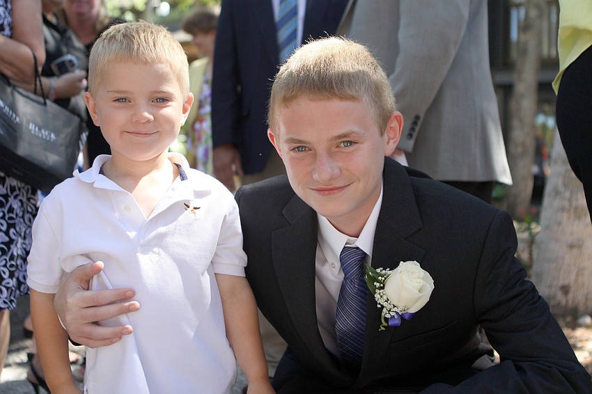 Caleb Cheney, 3, poses with his newly graduated brother, Cody, Friday, June 3 at ODA's 6th grade graduation at Siesta Key Chapel.