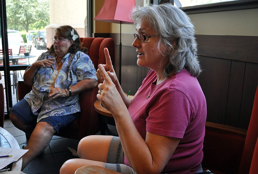 Phyllis Corbett signs to one of her friends during one of their Deaf Coffee Chats Saturday, June 18 at a Starbucks on the corner of Fruitville and University.