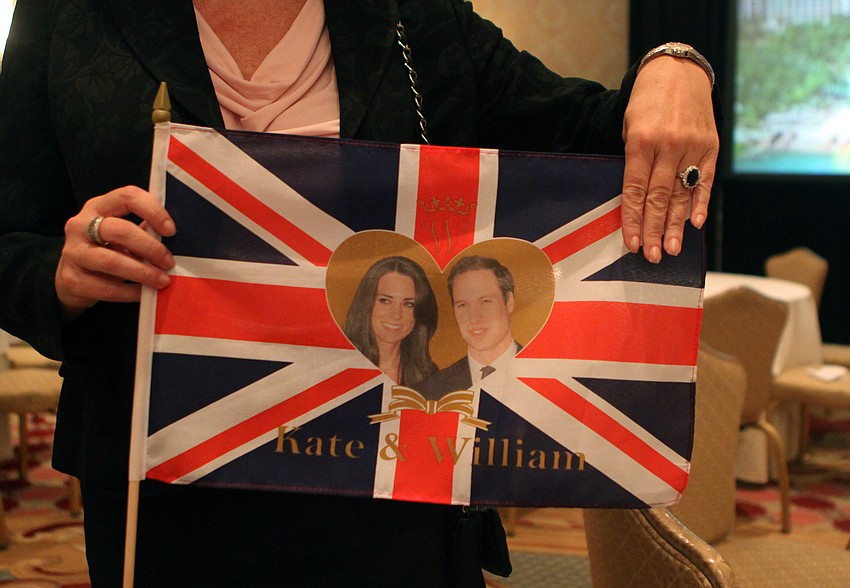 Suzanne Willis shows off the custom British flag she ordered from England and the knock-off royal wedding ring she bought at Michael's two days before the big event. Willis was the main organizer behind the Ritz Carlton event.