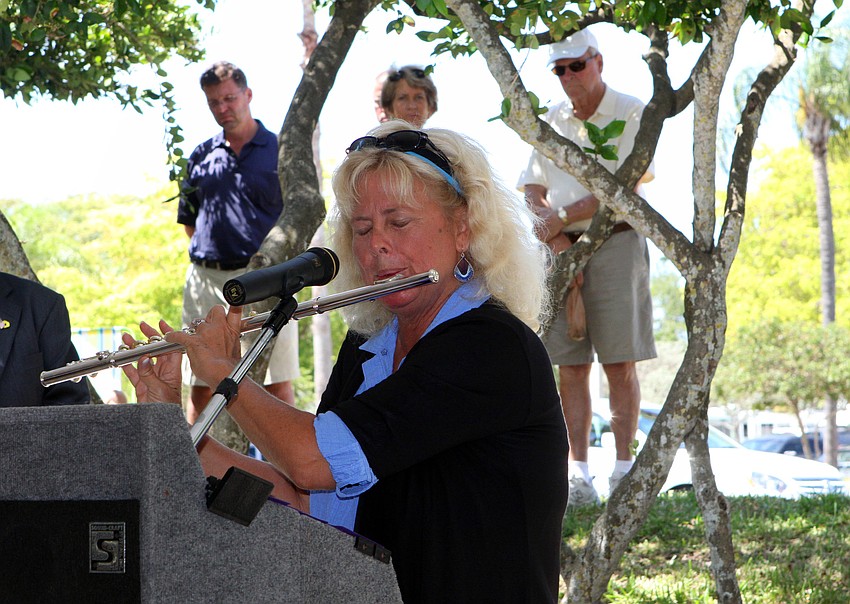 Janet Hamel Solomon plays a medley of patriotic tunes on the flute Monday, May 30 at the Honoring Our Fallen Heroes Memorial Day ceremony.
