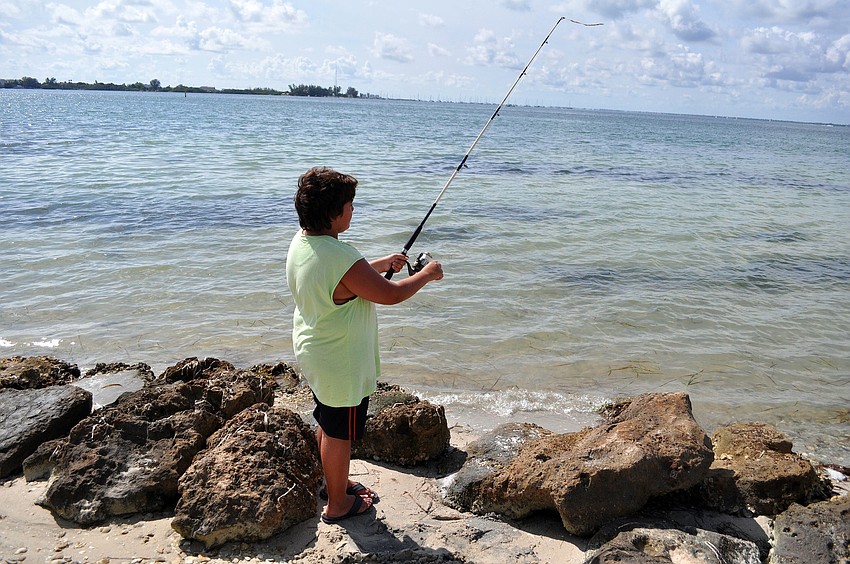 Edgar Morales, 11, fishes at Bird Key Park while on vacation with his family.