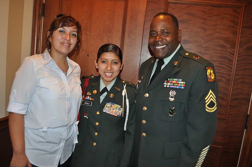 Sophomore Cadet Gloria Aguila, center, of Sarasota High School spent time with her sister Milena Aquila, and instructor Frederick Pulphus.