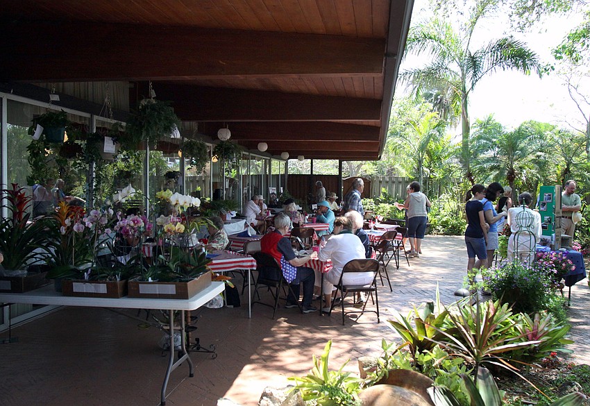 People enjoy eating lunch outside in the garden on Sunday, March 27 during the 74th Annual Sarasota Garden Club Flower Show.