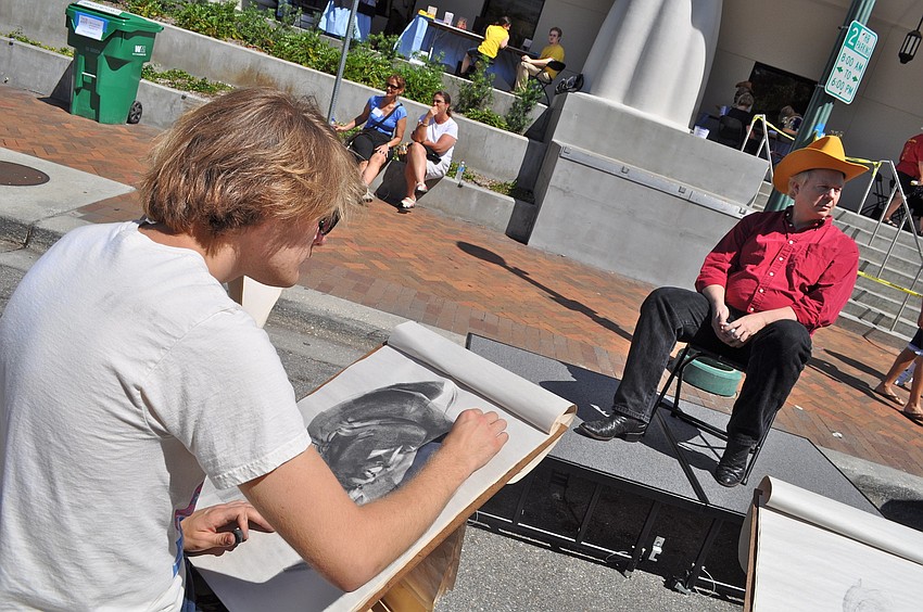 Matthew Decker, a third-year illustration student at Ringling College, sketches a live model in front of Selby Library.