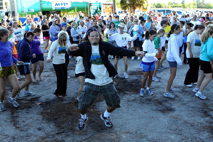 Christian Zinser, the DJ for the event, leads people in the 