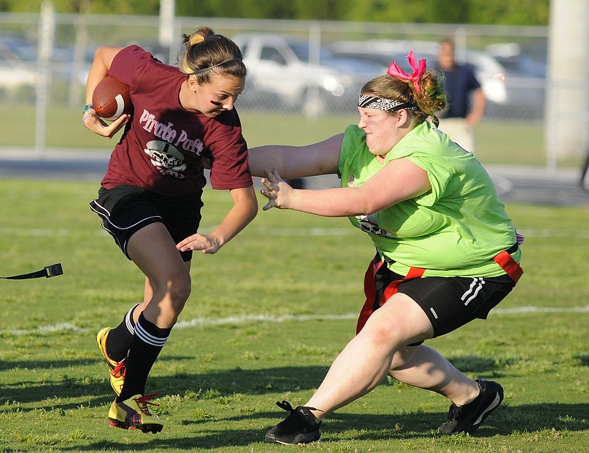 Freshman quarterback Sydney Ross tries to elude senior Olivia D'Amico.