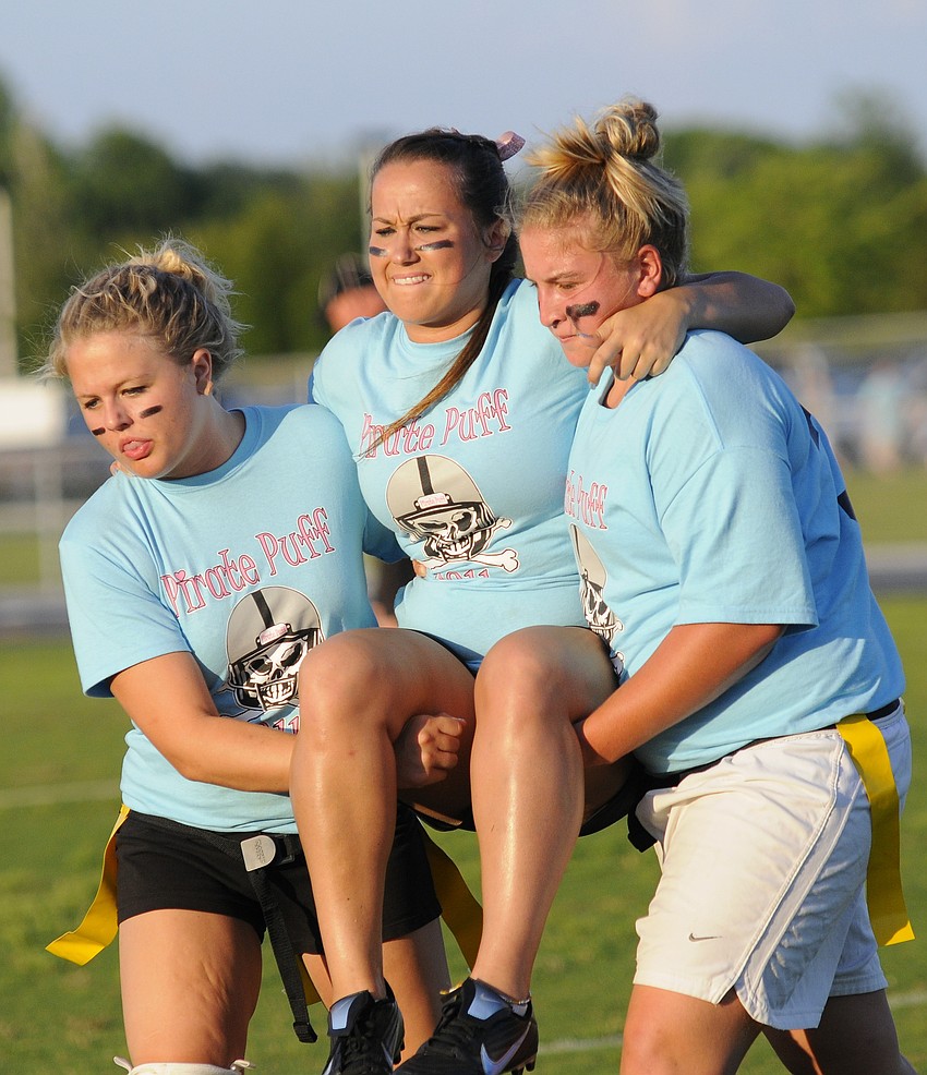 Juniors Kim Sump, left, and Alana Jackson carried teammate Veronica Colombaro off of the field after she injured her knee.