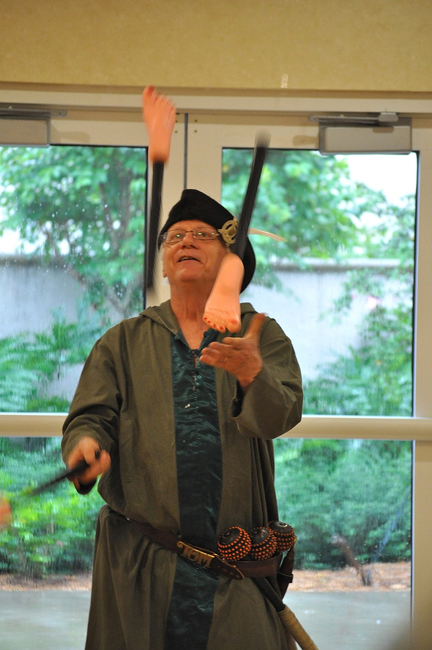 Tom Lemoine wows the crowd while juggling feet on a stick.