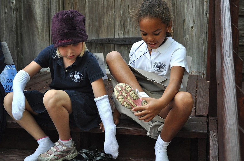 Ansley White and Ashley Jabri swap shoes during the race.