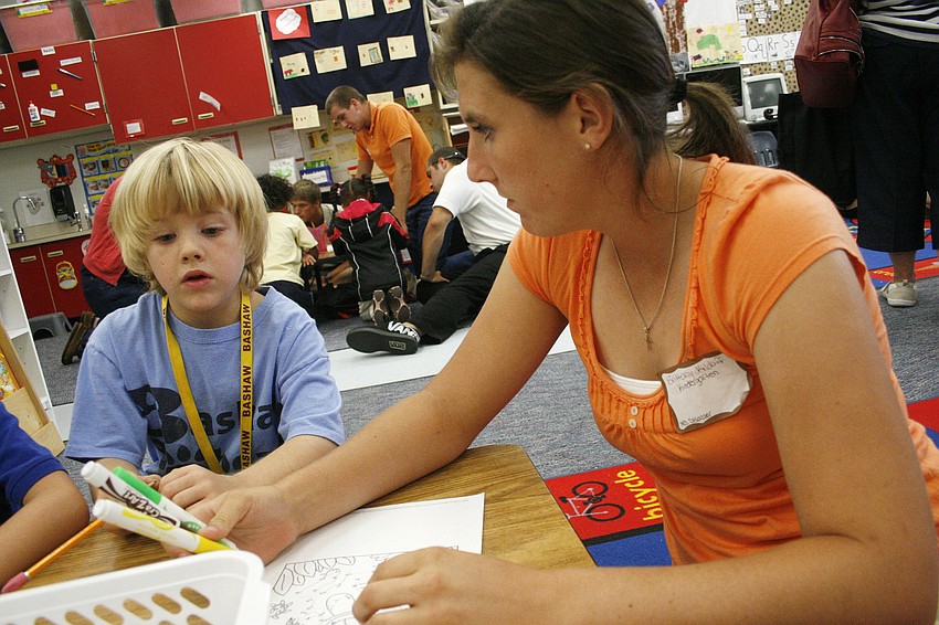 Lakewood student Brittany Kilduff helped Bashaw student Jacob Micca with an art project.
