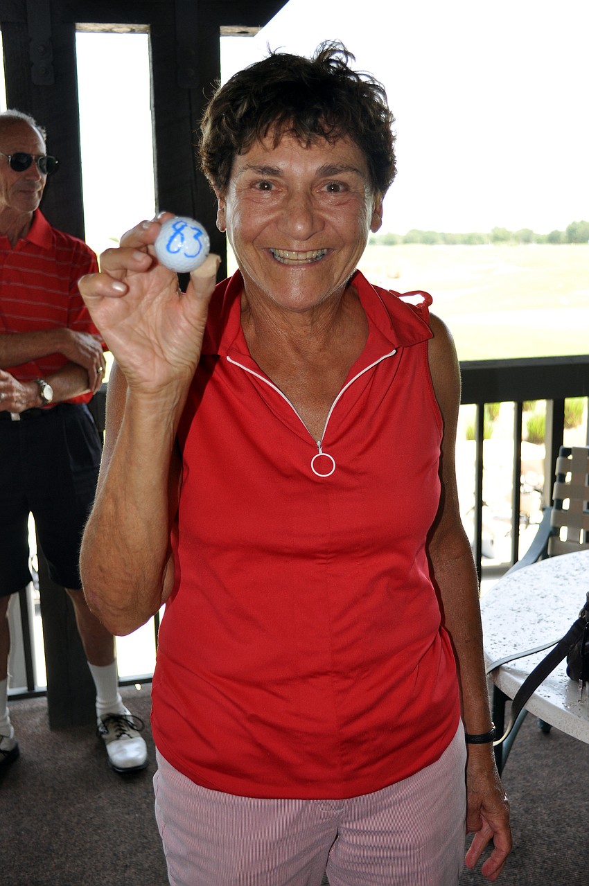 Marilyn Cohen won $630 after her golf ball landed closest to the pin during the helicopter ball drop.