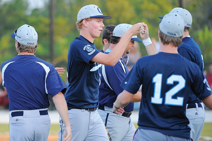 ODA pitcher Alex Horan is surrounded by his teammates after shutting down Shorecrest Prep's offense.