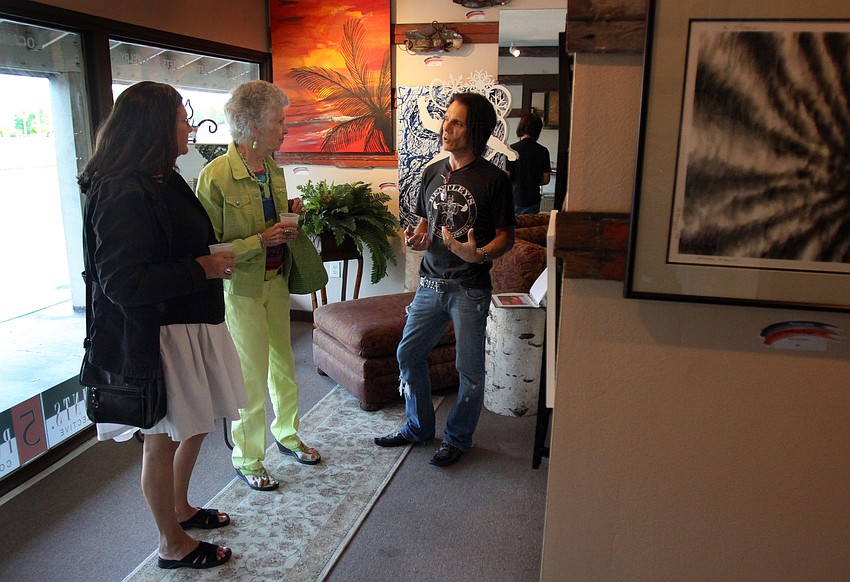 Rocky Bentley gives a tour to Lori Stepat and her mom, Mabel, Friday, May 6 during the Wine, Cheese and Beads event at Five Points Collective.