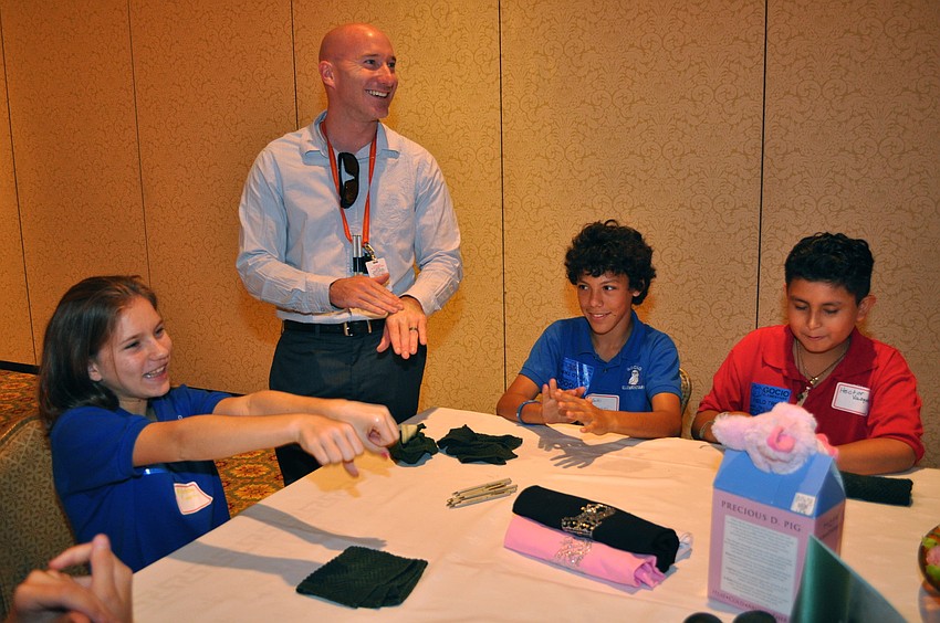 Alexandra Finnert, Gocio Elementary teacher Adam Gardner and Agustin Gualtieri get pampered by Ritz-Carlton, Sarasota's spa director and massage therapist.