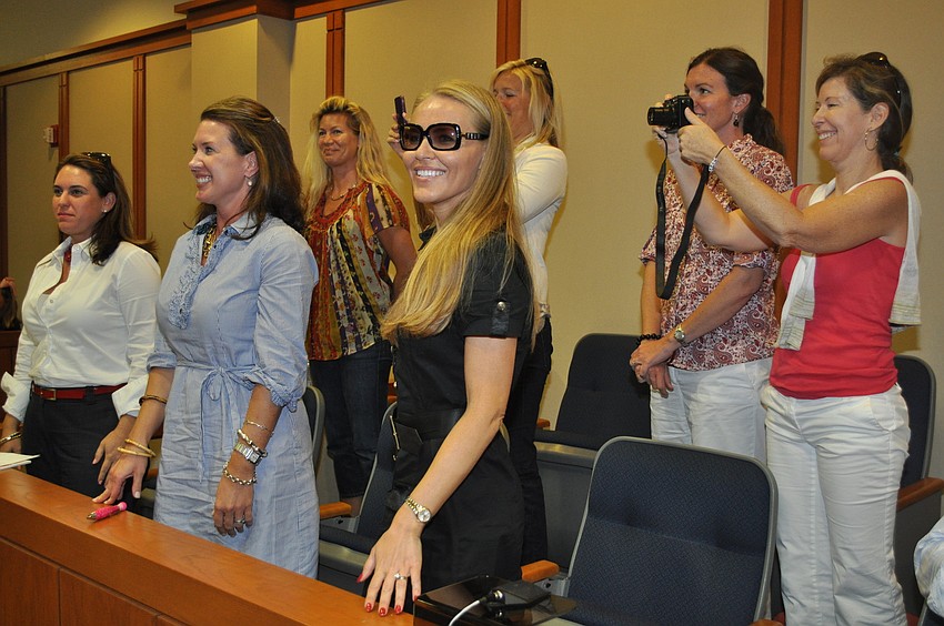 Second-grade moms gathered in the stands to document the trial.