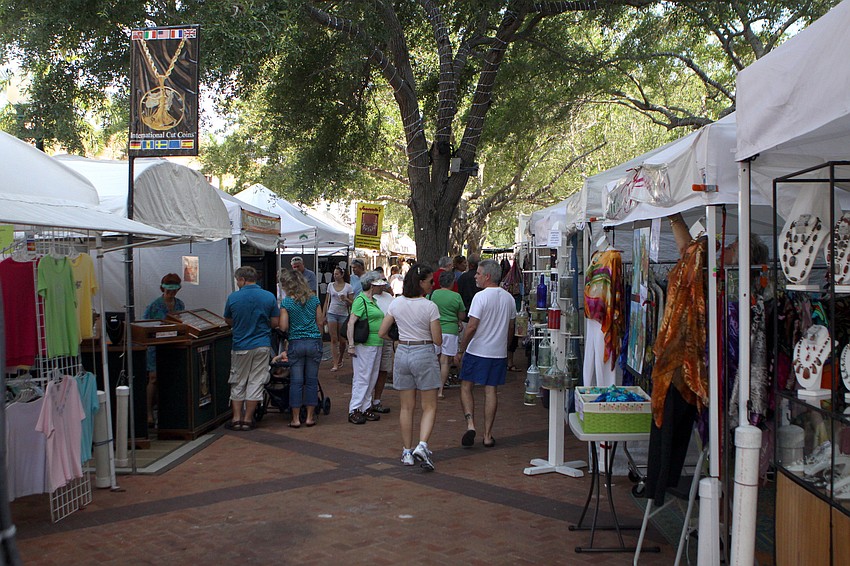 People wander around looking at the booths at the Craft Festival Sunday, May 22 along Main Street and in Five Points Park.