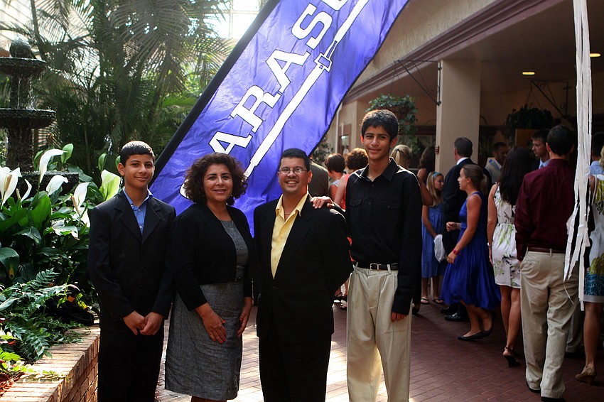 Spencer, Yolanda, Greg and Harrison Chona pose together in front of the Sarasota Crew banner at Sarasota Crew's Night of The Stars Sunday, May 22 at Michael's on East.