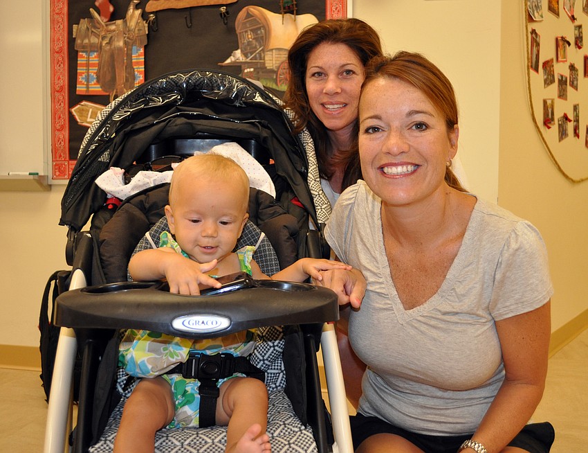 Wendy Freeman, back, caught up with Shirley Ridenour and her eight-month-old daughter Ally.