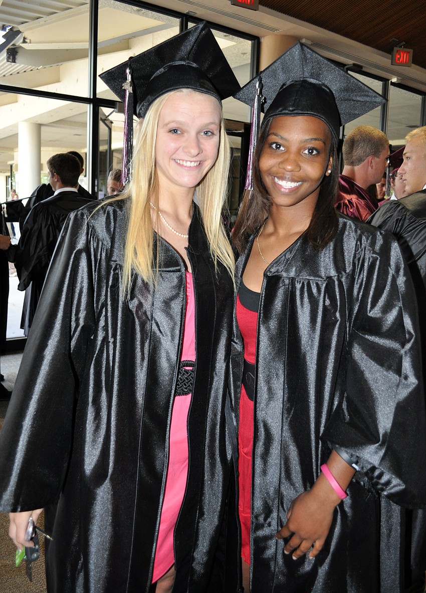 Student athletic trainers Rachel Hasson and Olivia Moore helped each other finish getting ready before graduation.